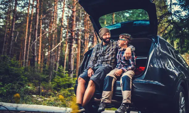 Father and son travelling by car in the forest. Gettyimages creative brief content: 69359735