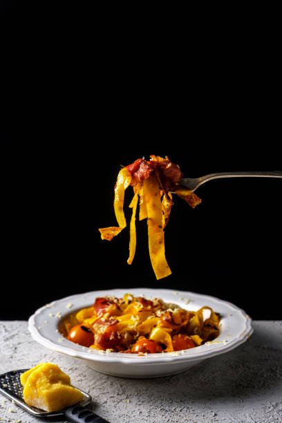 istock fettuccine pasta with cherry tomatoes and bacon. 647150368