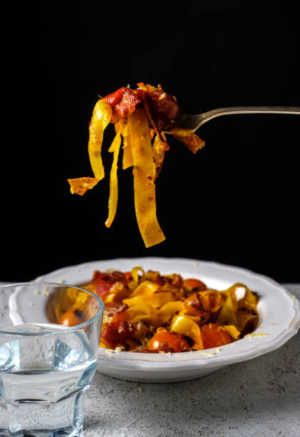 istock fettuccine pasta with cherry tomatoes and bacon. 647150418