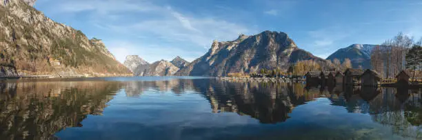 Beautiful panoramic photography of nature. The view is showing tall and sharp Traunstein mountains and Traunsee lake.  This is a local landmark of Ebensee and Gmunden. Mountains are mirrored in water