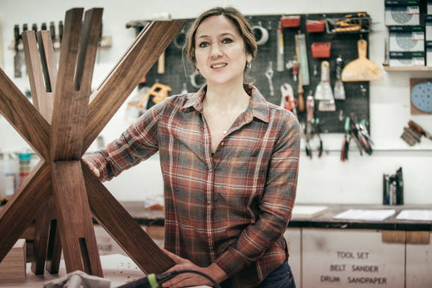 istock Furniture designer at her woodworking shop 647160502