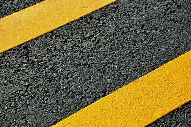 istock Concept of the transportation. Textural double solid lines on the asphalt road surface. 647160594