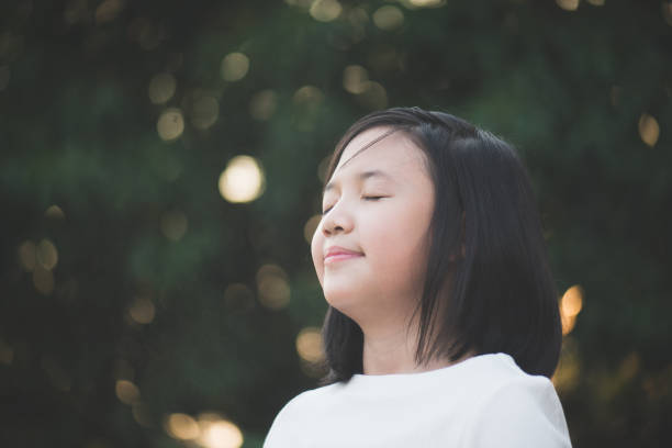 istock beautiful Asian girl with closed eyes 647167796