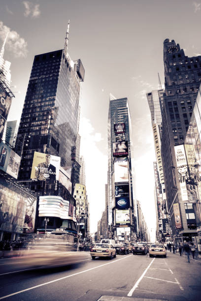New York City, USA - June 27, 2012: Streets Scene At Dusk Of Blurred Taxis In Times Square On 7th Avenue Close To Broadway In Midtown Manhattan