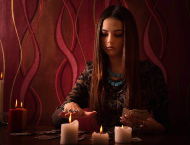 istock Young woman with divination cards in room 647171350