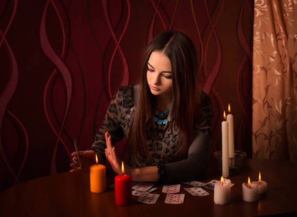 istock Young woman with divination cards in room 647171390