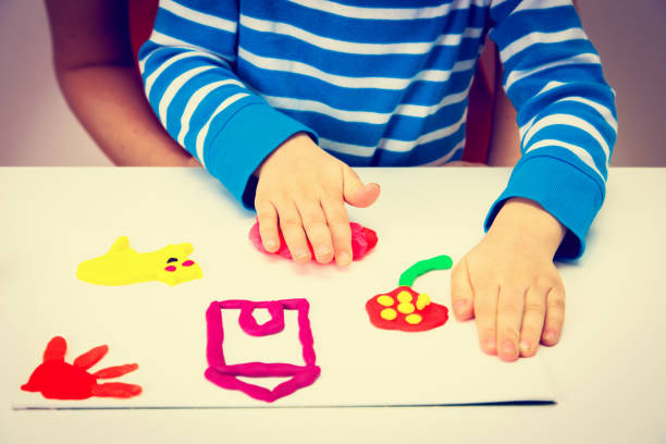 istock Child playing with clay molding shapes 647187772