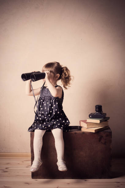 istock little girl with binoculars indoor 647191082