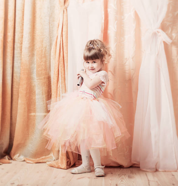 istock little girl with microphone indoor 647191228