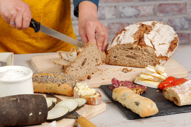 istock woman cuts a traditional  bread slice 647191712