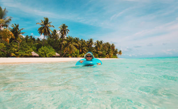 istock little boy in life ring swim on beach 647192168