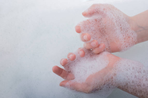 istock Child washing hands  in foam 647192504