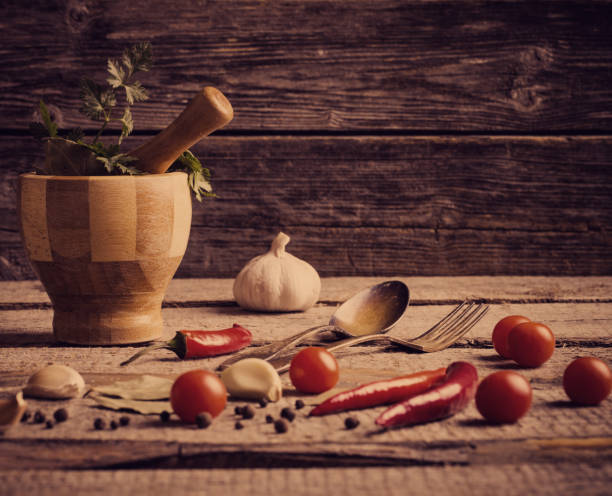 istock Mortar and pestle with pepper and spices on wooden table 647196692