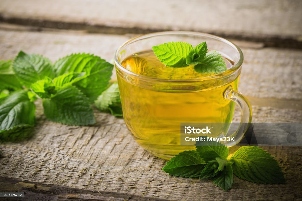 cups of tea with mint on wooden Tea - Hot Drink Stock Photo