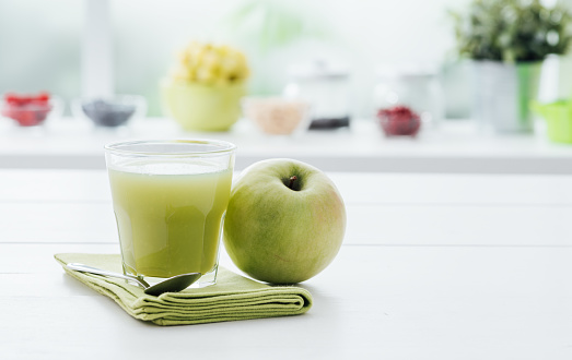 Fresh homemade green apple juice in a glass, detox and healthy diet concept