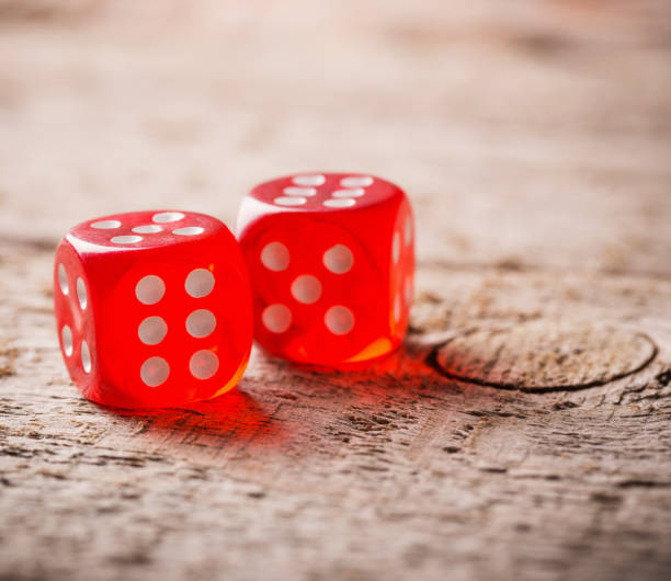 istock Pair of thrown red dices on old wooden table 647200708