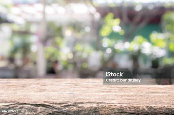 Wood Table Top And Blurred Restaurant Exterior Background Stock Photo - Download Image Now