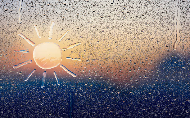 water drop forming a sun - condensation steam window glass imagens e fotografias de stock