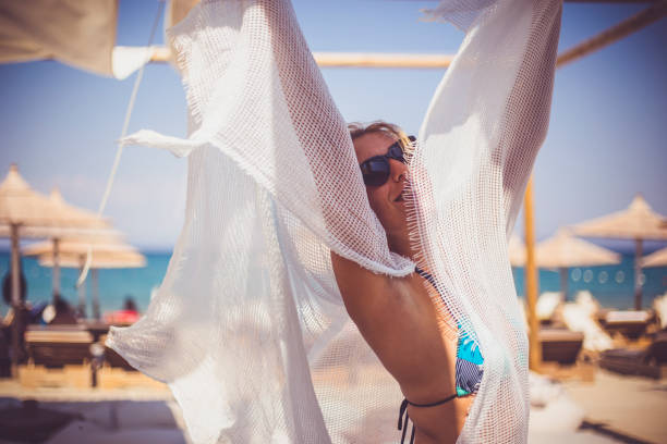 istock Happy woman in bikini posing on beach 647211798