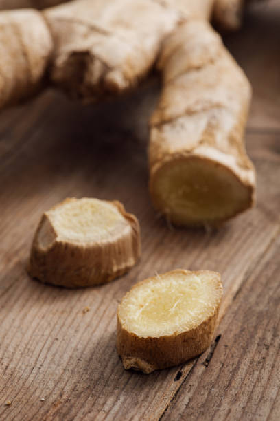 istock Fresh sliced ginger root on a rustic wooden table, cooking and seasoning concept 647220888