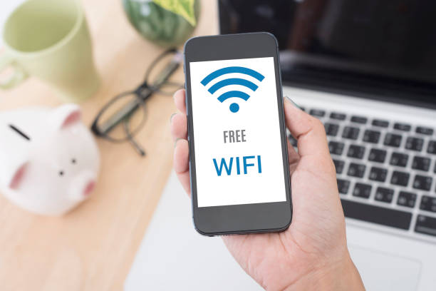 istock Business hand holding smart phone with Free wifi access connection 647221090