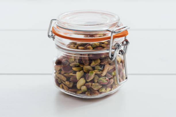 istock Roasted salted pistachios in a glass jar with lid 647221322