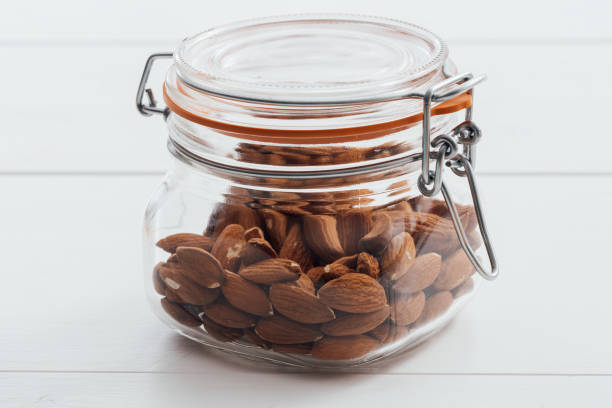 istock Almonds in a glass jar with lid, diet and nutrition concept 647221324