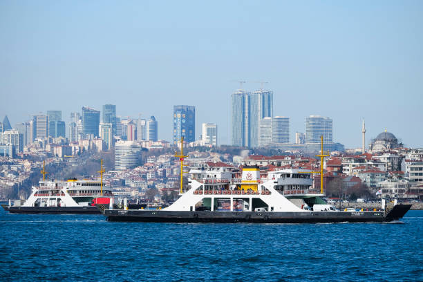 Istanbul, Turkey - February 26, 2017: Ferryboats at The Istanbul Bosphorus with passengers, vehicles and skyscrapers.