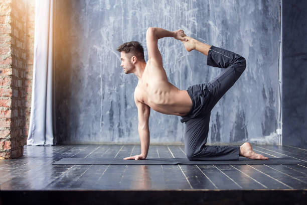 istock Yoga men workout on black mat. 647228254