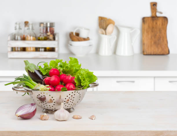 istock Fresh vegetables on wooden table over blurred kitchen counter interior 647228568