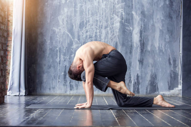 istock Yoga men workout on black mat. 647231210