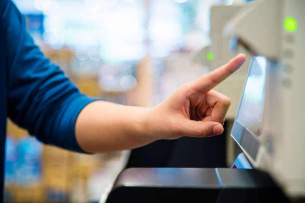 istock Close up of a woman using a self checkout machine 647231228