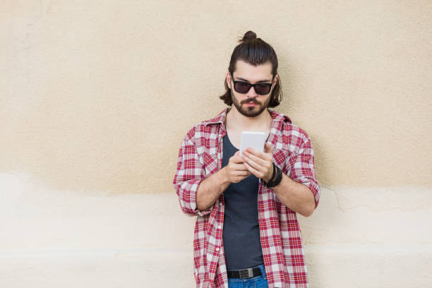 istock Modern urban guy with a cellphone outdoors. 647231794