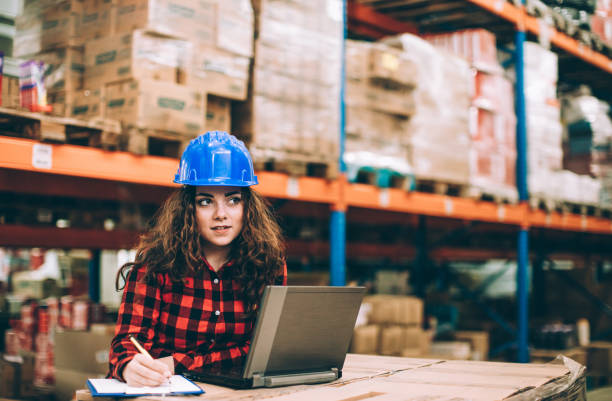 istock Businesswoman at warehouse checking inventory 647231822