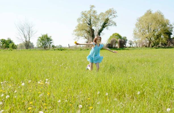 istock girl on flower meadow 647231914