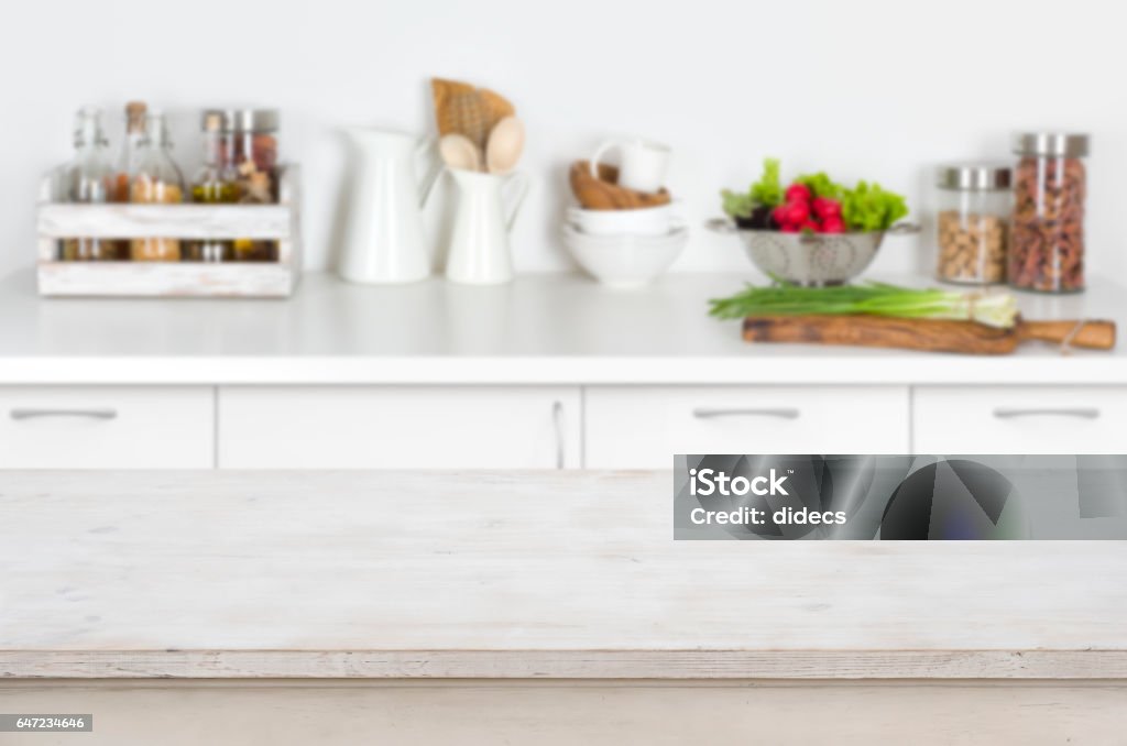 Wooden table on blurred kitchen interior background with fresh vegetables Kitchen Counter Stock Photo