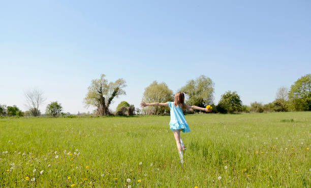 istock girl on flower meadow 647234732
