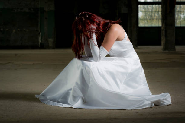 young bride sitting with her hands in her hair before the wedding