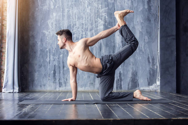istock Yoga men workout on black mat. 647235858