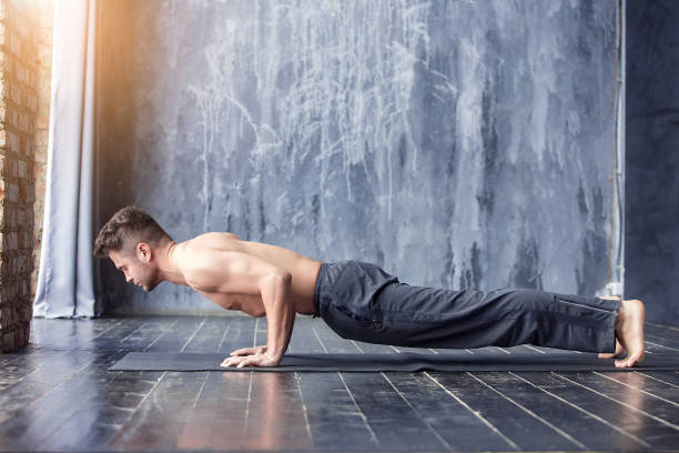 istock Yoga men workout on black mat. 647236250