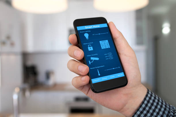 istock man hand holding phone smart home background home room kitchen 647240238