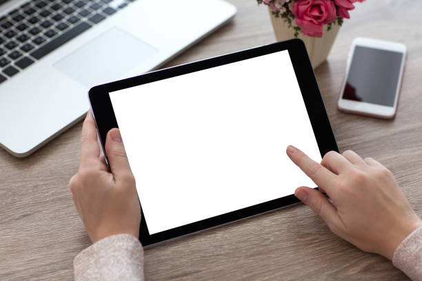 istock woman hands holding tablet PC computer with isolated screen 647243160