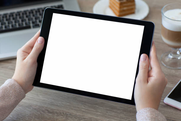 istock woman hands holding tablet PC computer with isolated screen 647243248