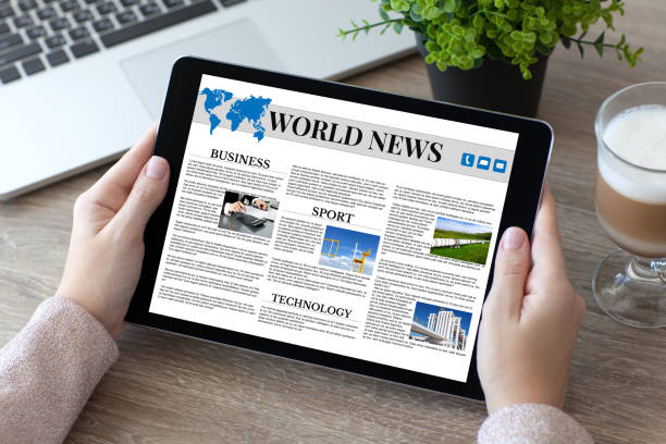 istock woman hands holding tablet PC computer with world news 647243578