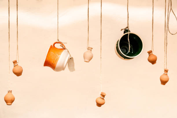 cups and clay pots hanging on the ropes, the design and interior of the restaurant for a coffee bar, a creative way to place items for sale
