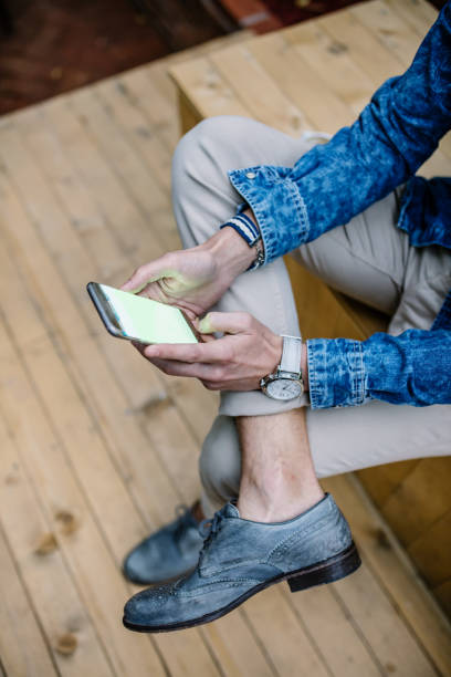 istock Close up of a man checking his email on his phone 647251322