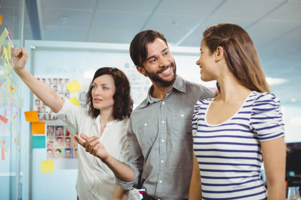 istock Team of executives discussing over sticky notes 647251472