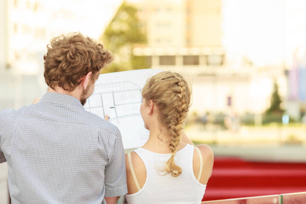 istock couple with blueprint project  building plans outdoor 647252318