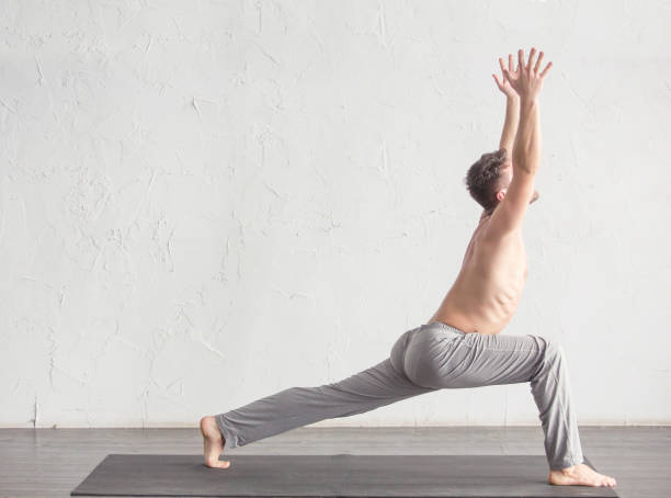 A man doing yoga exercises stock photo