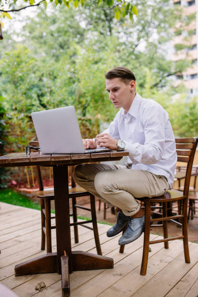 istock No minute without my laptop. Handsome young man working on laptop 647255748
